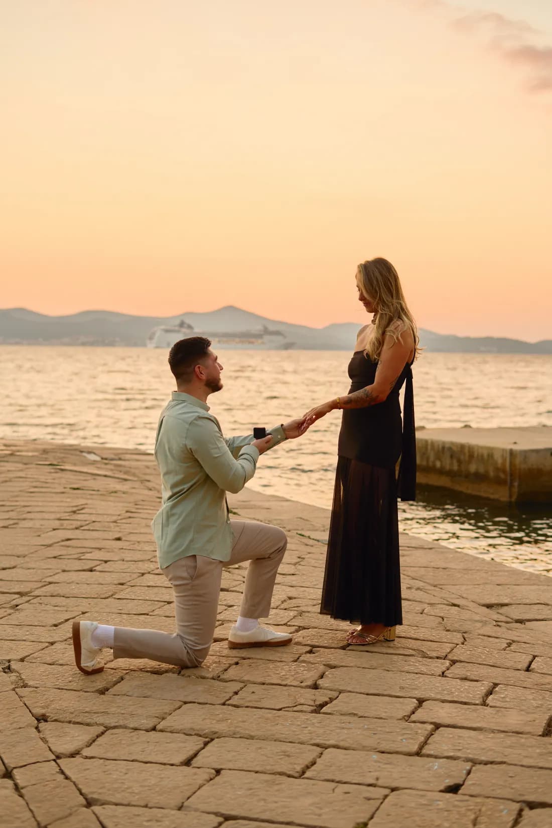 Man kneeling with an engagement ring during a surprise proposal in Zadar