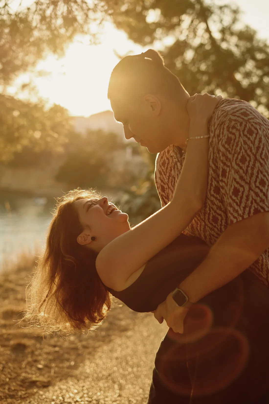 Couple laughing through happy tears after the proposal