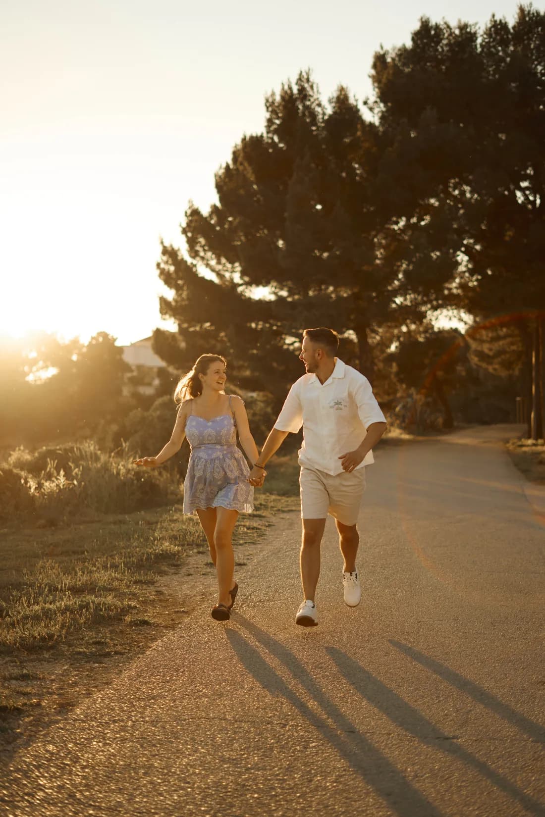 Newly engaged couple embracing at golden hour by the Adriatic
