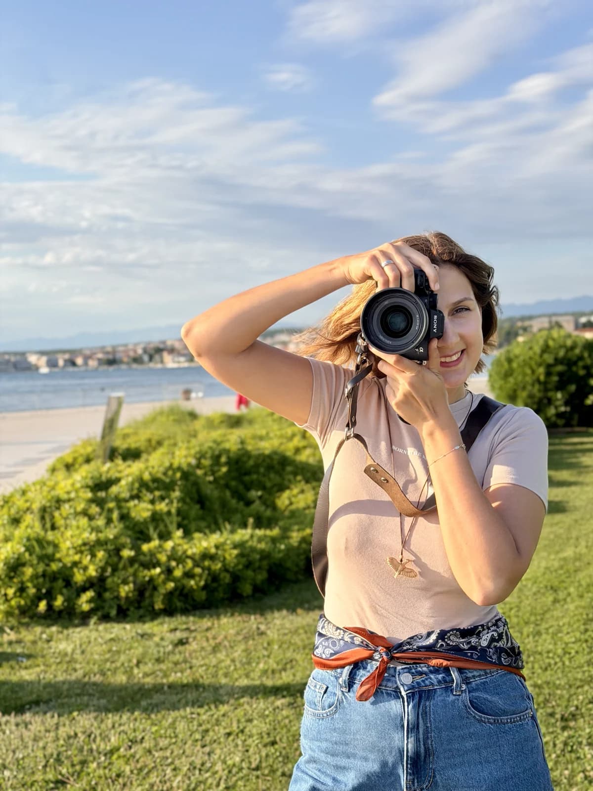 Mariia photographing by the sea in Zadar