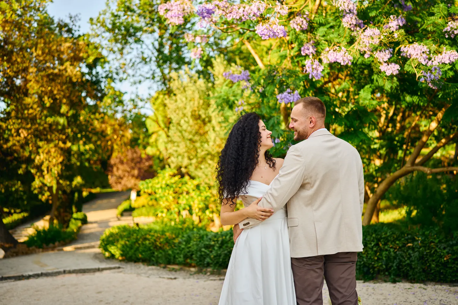 Bride and groom together in a green garden