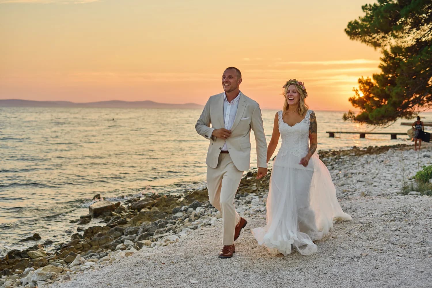 Couple walking the shore in golden evening light