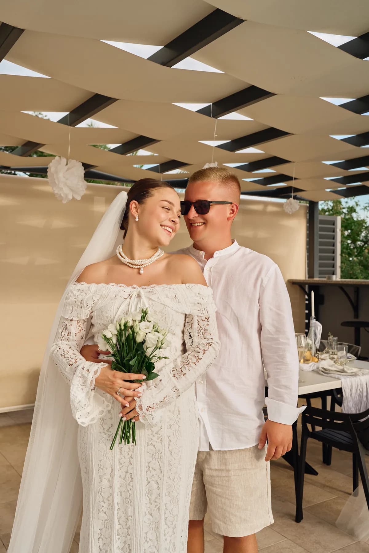 Bride and groom with her bouquet during the celebration