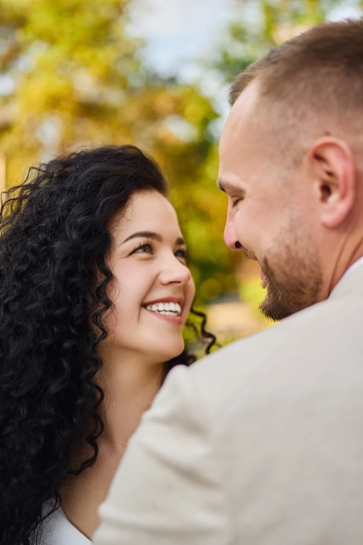 Close portrait of the bride smiling at her groom