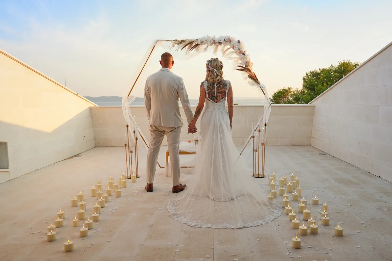 Newlyweds on the candlelit aisle after the ceremony