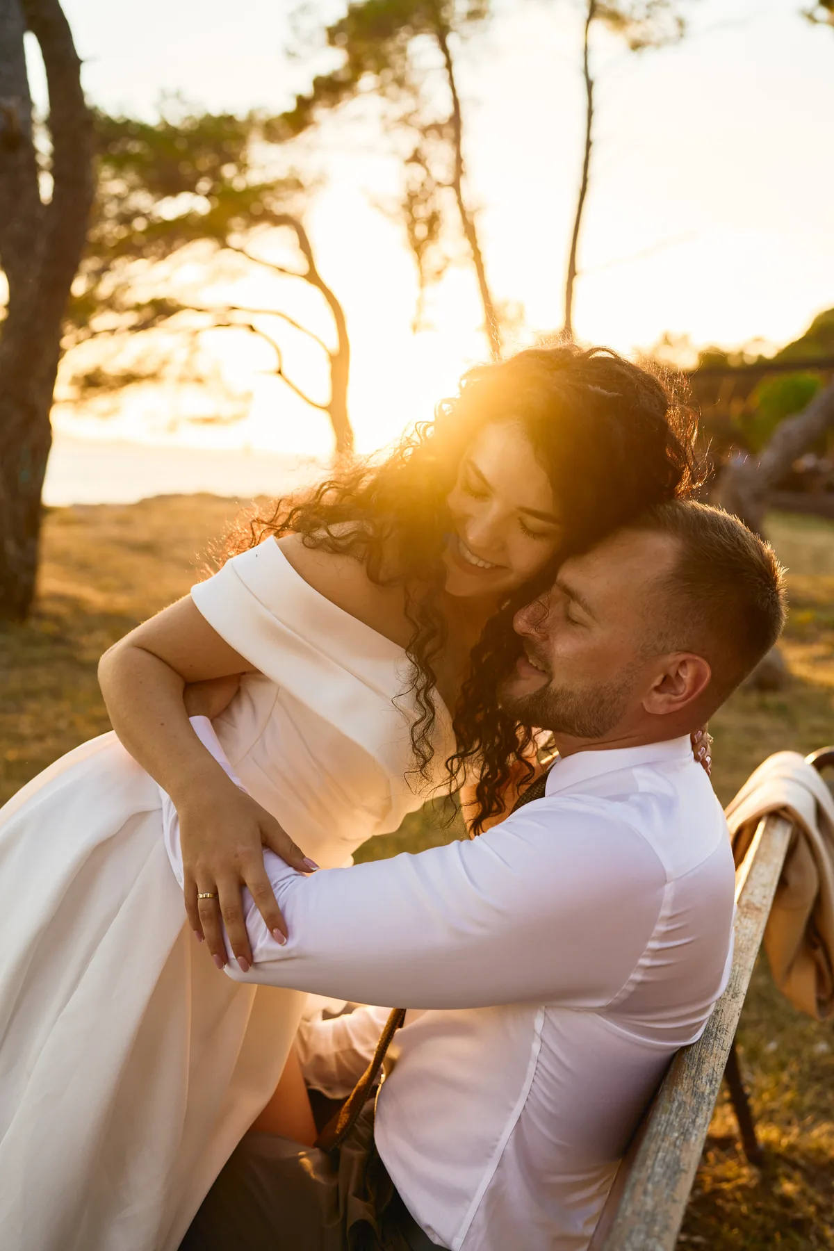 Bride and groom embracing at golden hour by the Adriatic in Zadar, Croatia