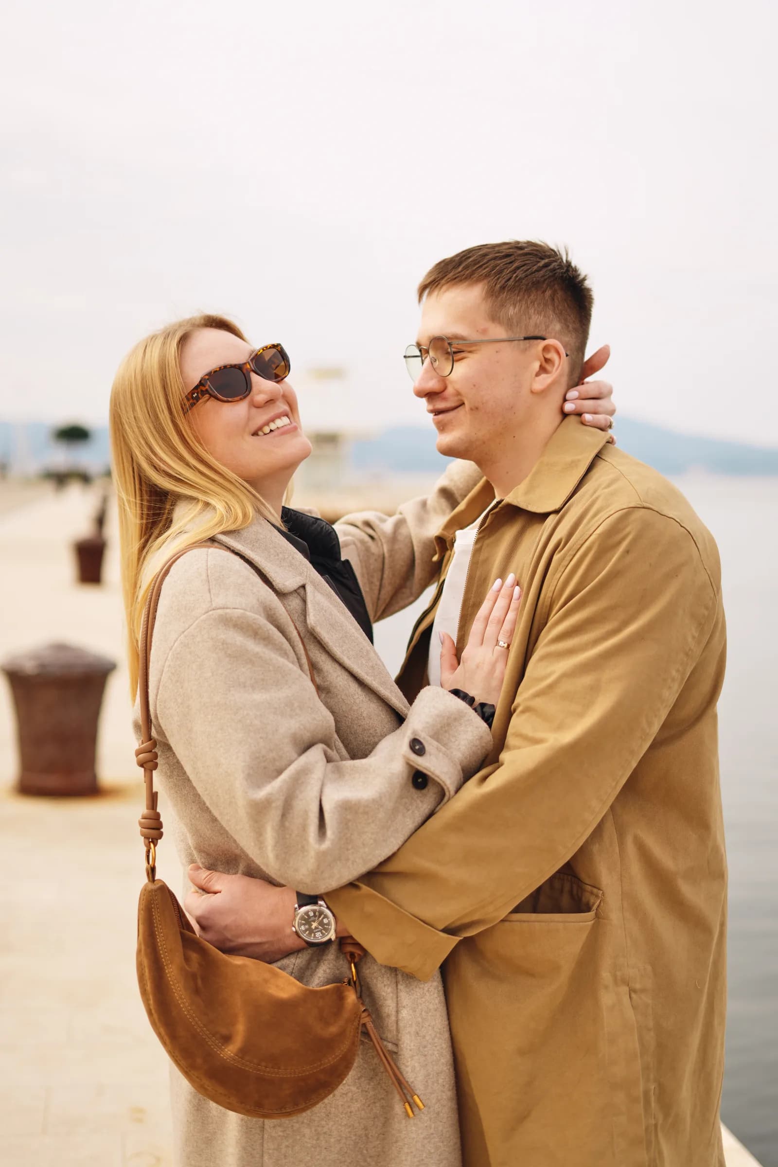 Couple smiling together on the seaside promenade