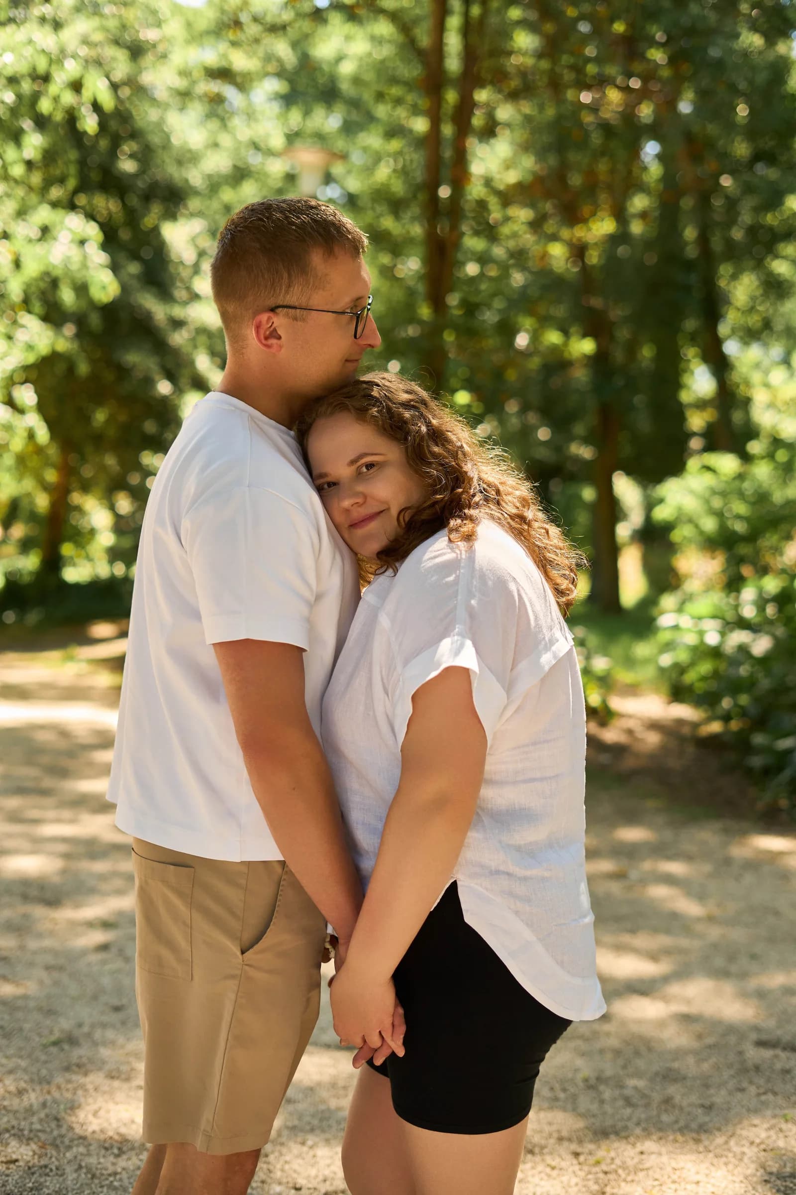 Couple hugging in soft forest light