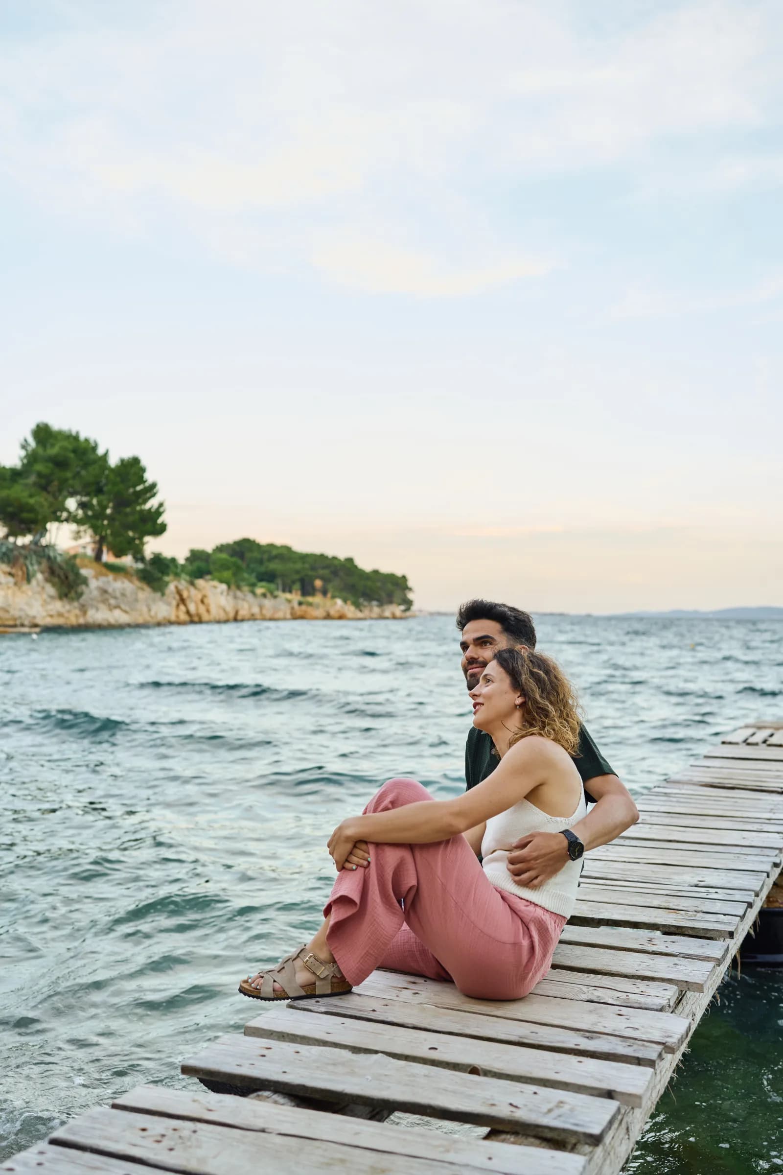 Couple sitting close on a seaside dock in Zadar