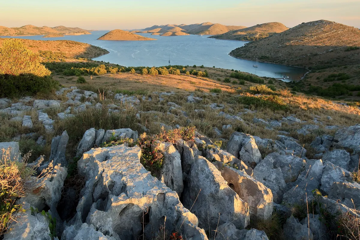 The Kornati islands at sunset, bare karst turning gold above the sea