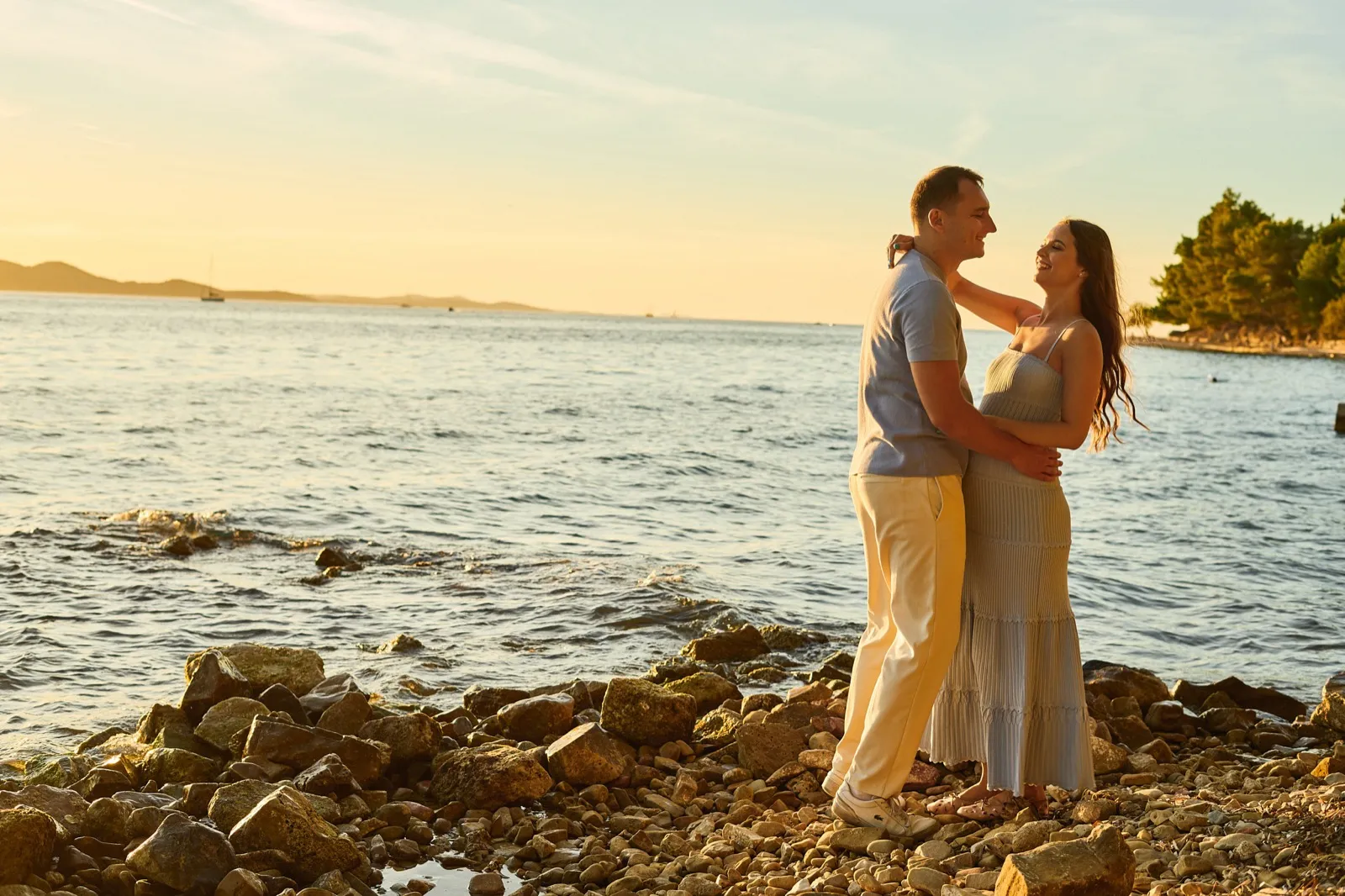 A couple at golden hour in soft, coordinated tones on the Zadar coast